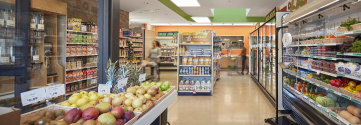 An overview look at the Fresh Market with freezer on against the right walls and product and snacks in the middle and left