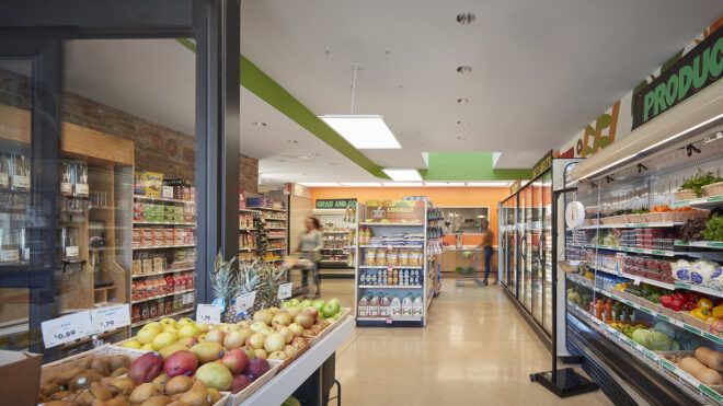 An overview look at the Fresh Market with freezer on against the right walls and product and snacks in the middle and left