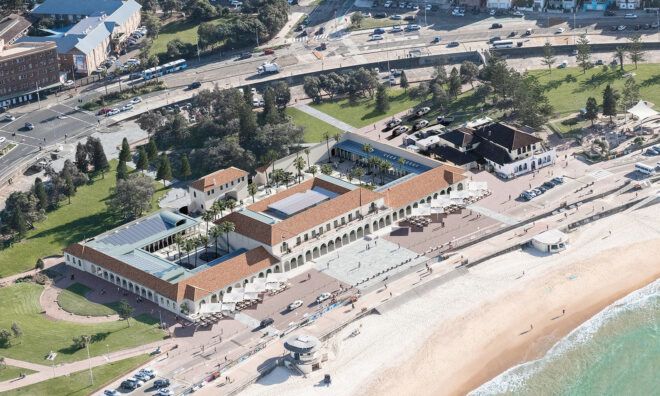 An aerial view of the North Bondi Surf Club building set behind a beach