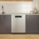 A stainless steel dishwasher displayed within a kitchen cabinet