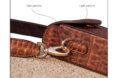 Side view of a Leukeather crossbody bag on a cork surface