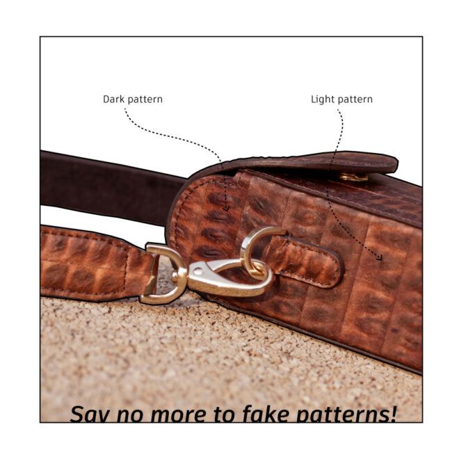 Side view of a Leukeather crossbody bag on a cork surface