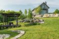 A farmhouse within a span of green grass