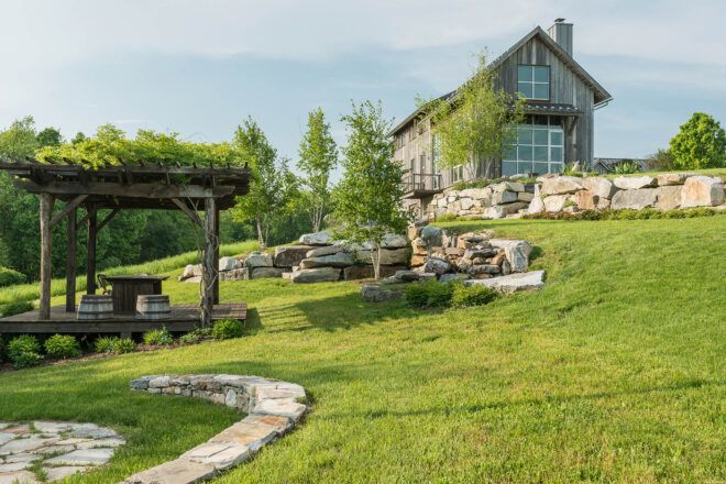 A farmhouse within a span of green grass