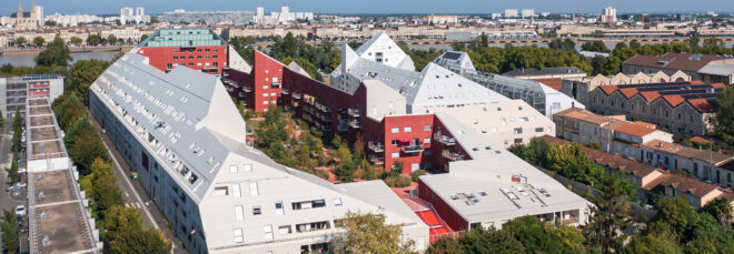 An aerial shot of the Ilot Queryries, varying white buildings with peaks of read painted buildings