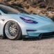 The front of a blue Tesla car