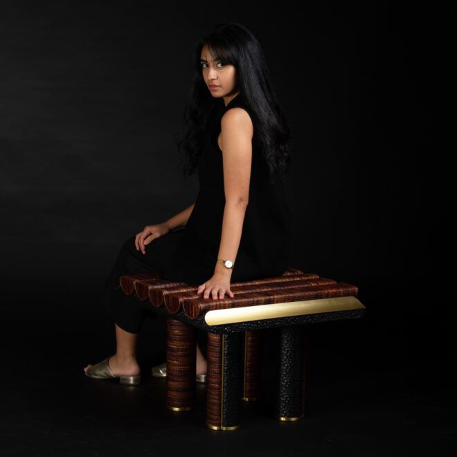 Designer Nuhayr Zein seated on an ottoman from Leukeather's SEEDS Series, facing the camera