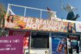 A convenience market with a sign that says 