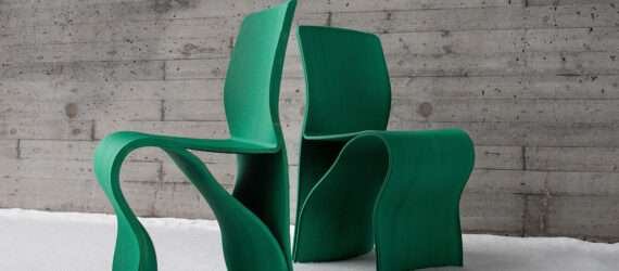 Two green chairs with their backs facing each other