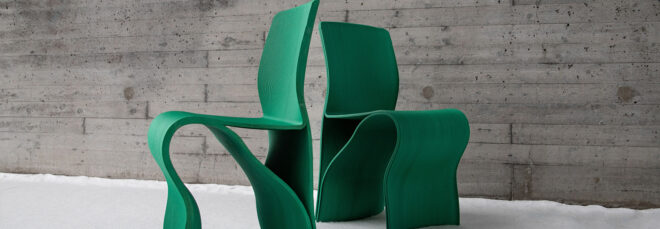Two green chairs with their backs facing each other