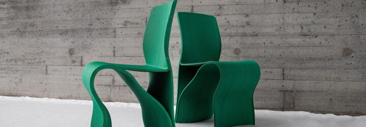 Two green chairs with their backs facing each other