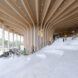 Inside of a wooden structure with white staircase