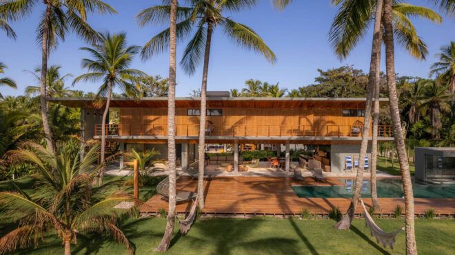 A wooden home hidden among palm trees