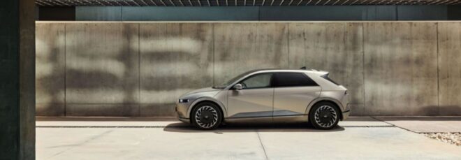 The side view of an electric vehicle driving on a cement area