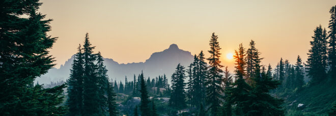 Sunset horizon along a mountain and forest area