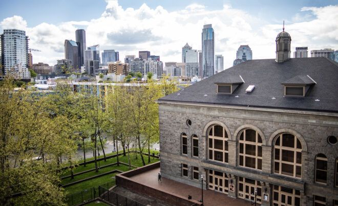 A brick building facing the skyline of Seattle