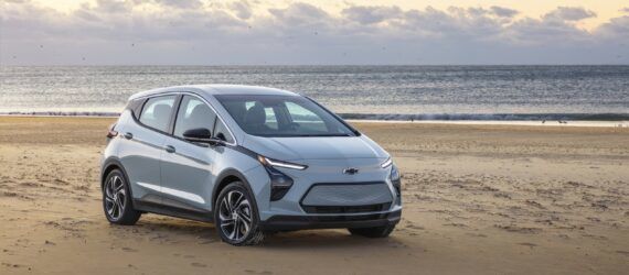 A Chevrolet Bolt EV car in a beach area