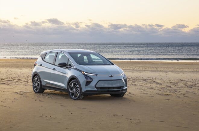 A Chevrolet Bolt EV car in a beach area