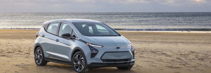 A Chevrolet Bolt EV car in a beach area