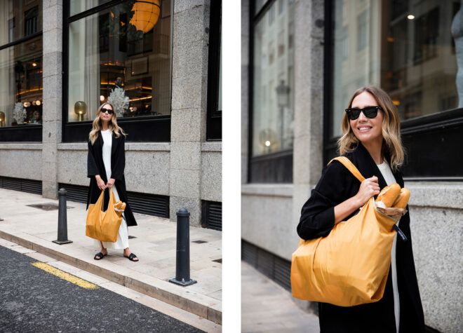 A woman posing with a yellow tote bag