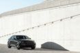 A black vehicle driving down a concrete slope