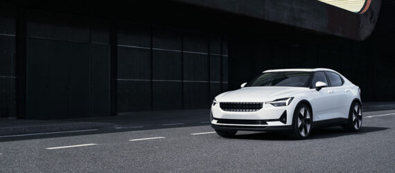 A white car driving down a street