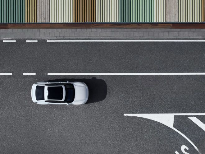 The top of the car driving down a street