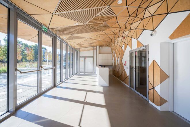 The ground floor inside the building with geometric tiles on the ceiling