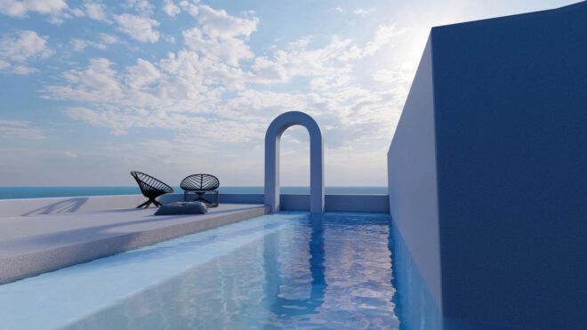 An archway surrounded by a pool and the sea in the distance