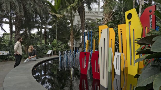 Another angle of a sculpture of colorful panels set in a pool of water