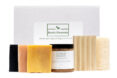 A white Rustic Elements box with bars of soap displayed in front of it