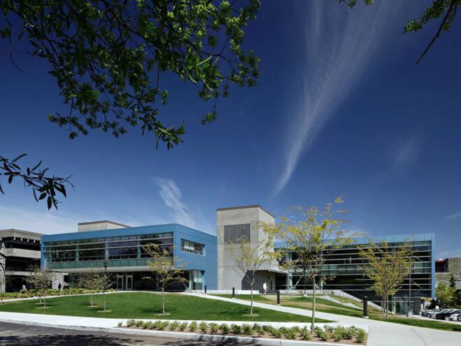 The front of the college with a blue parking structure