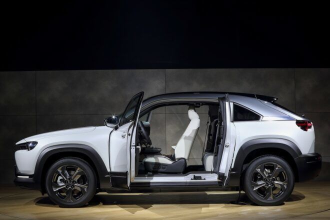 The side of a silver car with the driver door open