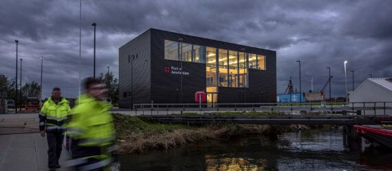 A black rectangular building during a stormy and overcast day