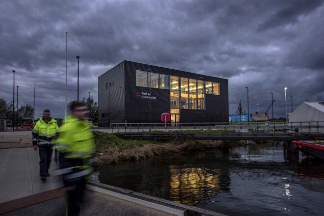A black rectangular building during a stormy and overcast day