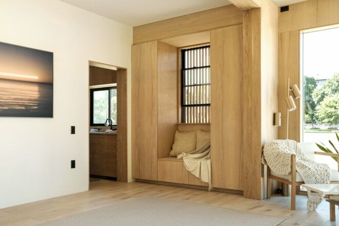 The sunlit interior of the Studio villa with seating built into the wall.