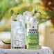 Two cups of clear alcohol with slivers of lime
