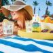 A woman wearing a straw hat with cool summer drinks next to her
