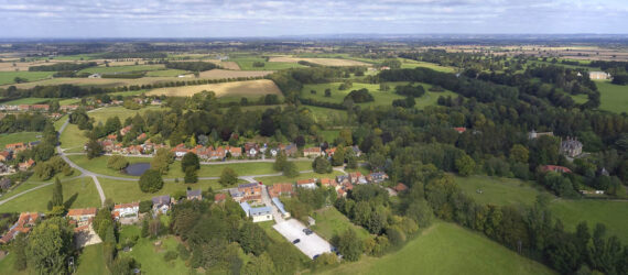 A farther aerial view of the pub with nearby housing structures