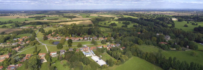 A farther aerial view of the pub with nearby housing structures