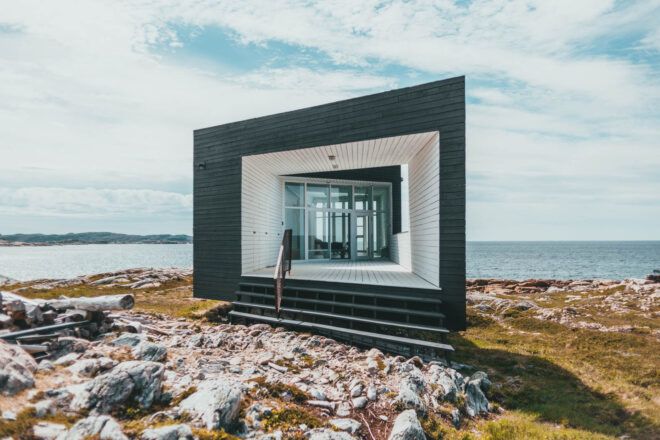 A tiny house set near a lake or ocean