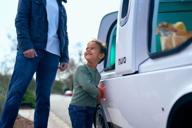 A child close to the vehicle smiling