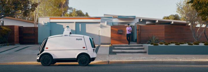 Nuro parked outside a house as someone walks toward it