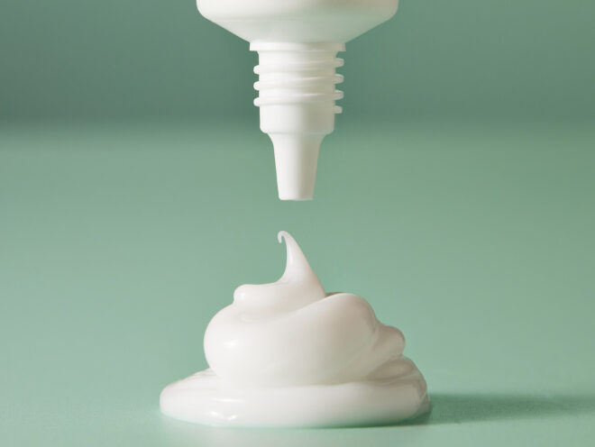 A white dollop of cream from a white tube