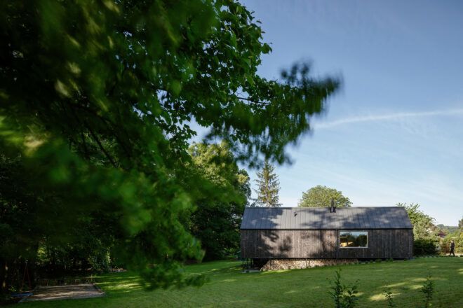 The KLAR house near trees on green land