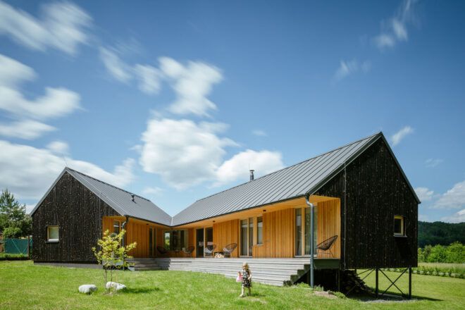 The back of the house with wood walls and metal roof