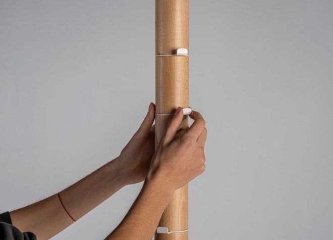 Two hands on a coat rack