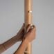 Two hands on a coat rack