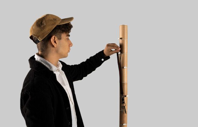 A man is touching a wooden modular coat rack