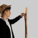 A man is touching a wooden modular coat rack
